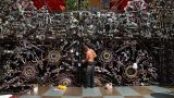 An employee paints the outer decoration of a cafe bar in Prague's district of Holesovice